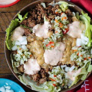 cheeseburger bowl with napkin and toppings on the side