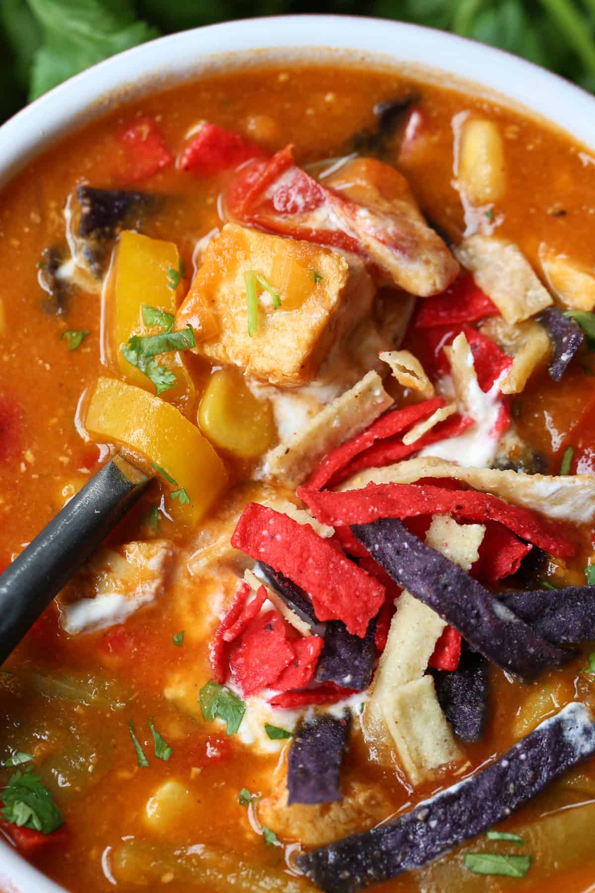 chicken fajita soup in a bowl with spoon