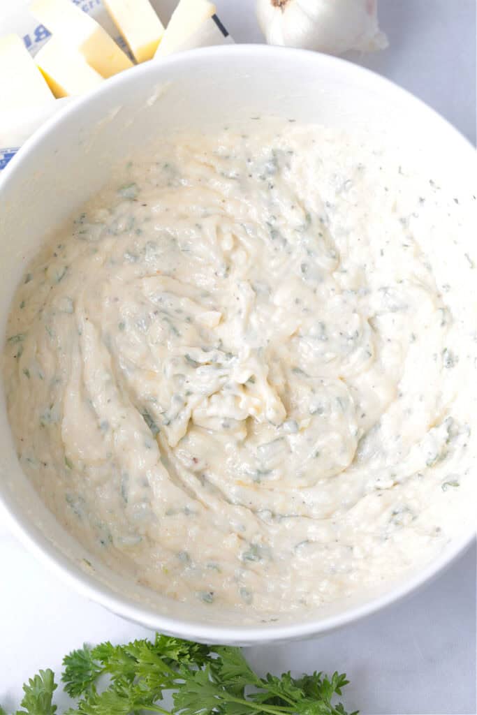 mayonnaise sauce with parsley in a white bowl