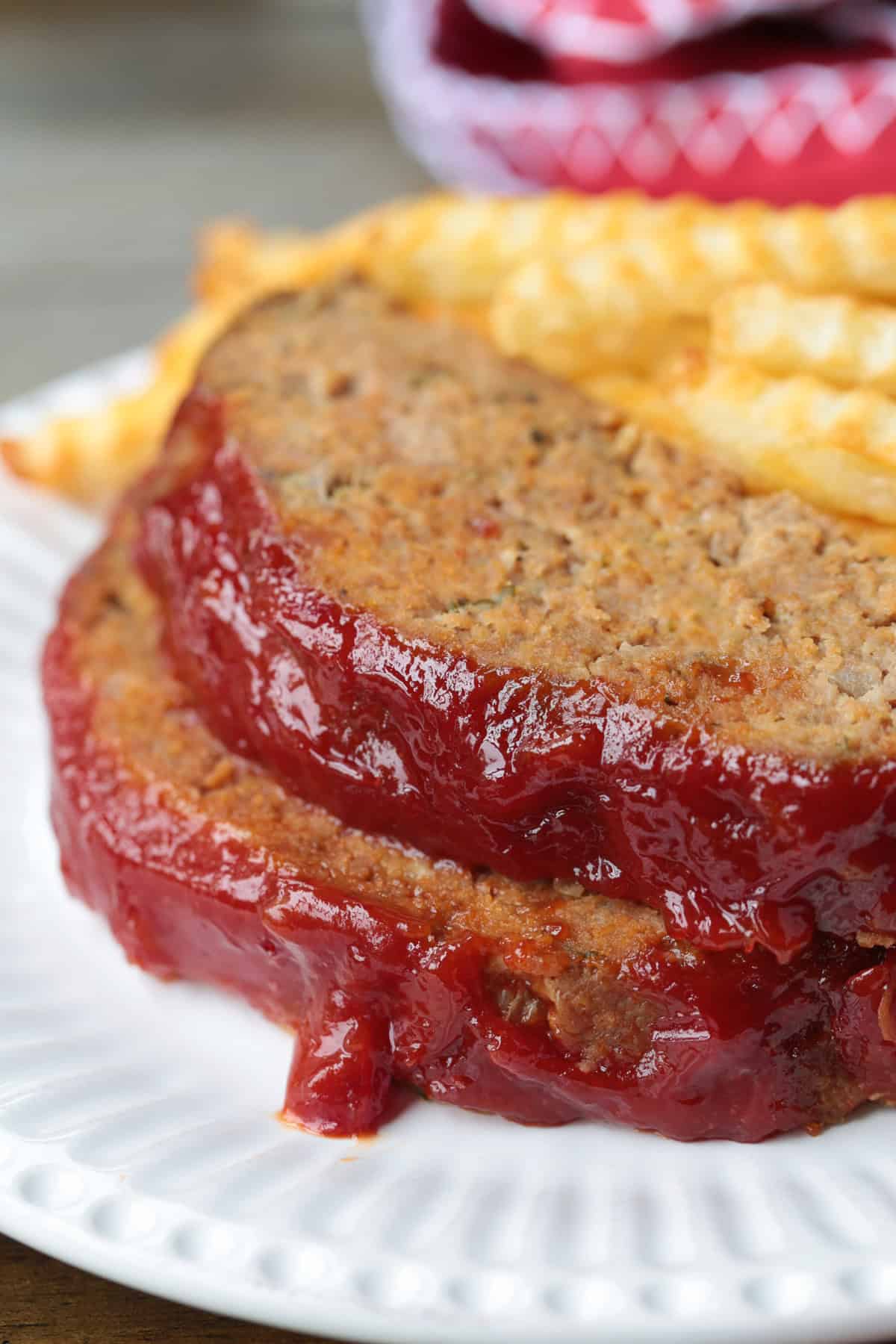 stacked meatloaf slices with glaze on white plate